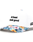 White cap with floral brim and text on a white background