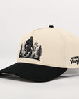 Beige and black cap with a Sasquatch graphic on a white background