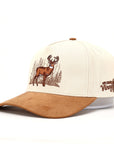 Beige and brown suede cap with deer design and text on a white background