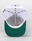 green brim underneath white hat