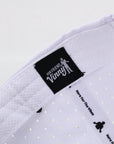White fabric with black label and text on a light gray background