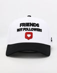 White cap with black text 'FRIENDS NOT FOLLOWERS' and a red heart symbol