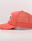 Coral pink trucker cap with mesh design and white logo