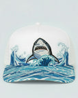 Cap with a shark design on a wave pattern against a light gray background