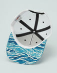 Cap with blue wave pattern on a white background