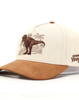 Beige and brown cap with a dinosaur and palm tree design on a white background