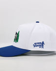 White and blue cap with embroidered designs on a light gray background
