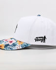 White golf hat with floral brim logo side