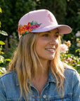 pink cap with floral designs on side