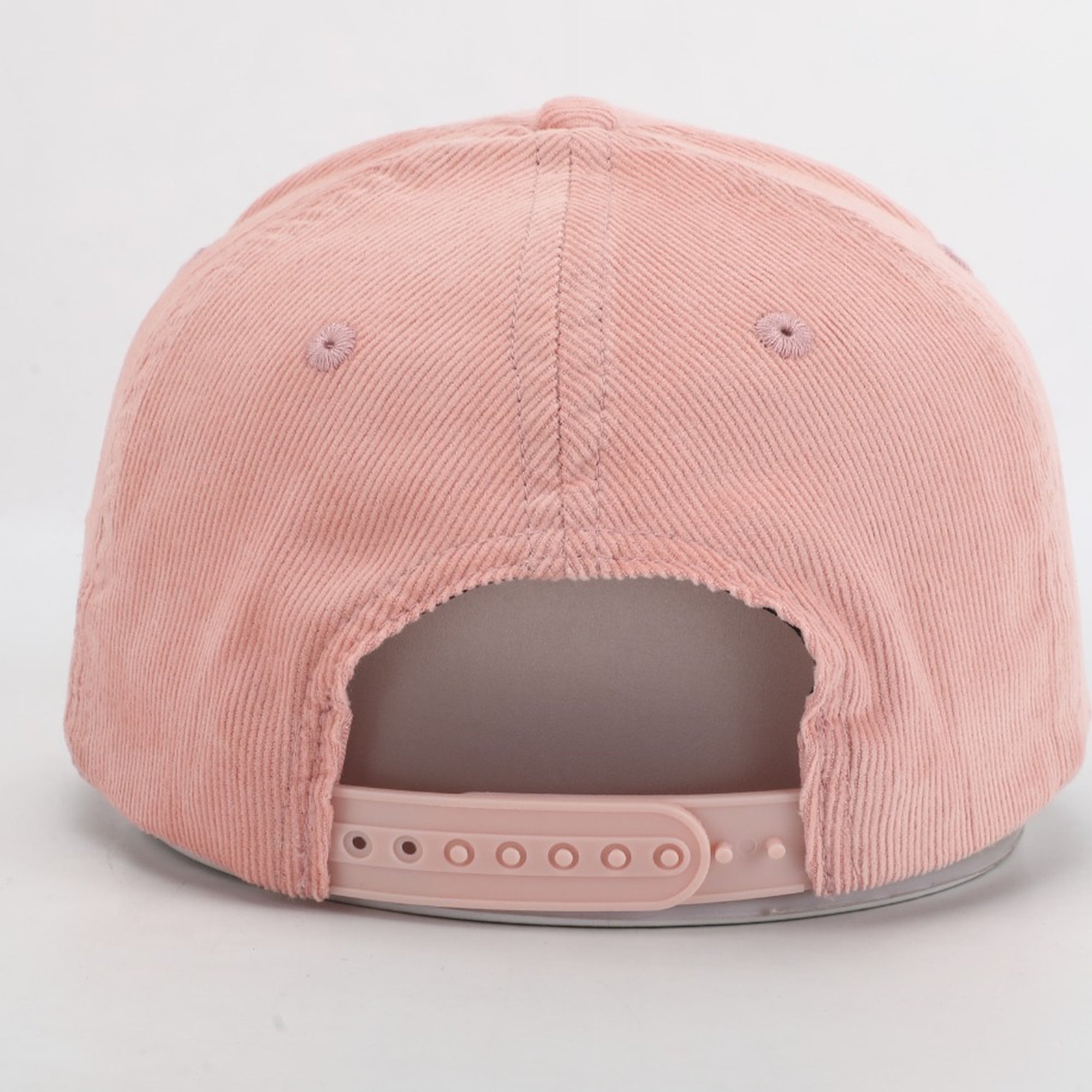 Pink corduroy cap on a light gray background