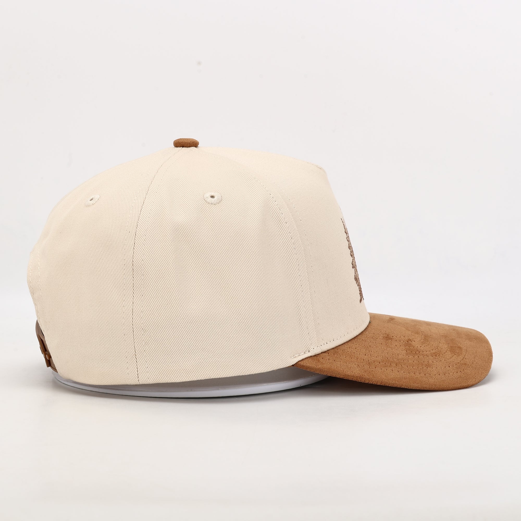 Beige and brown baseball cap on a white background