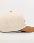 Beige and brown baseball cap on a white background