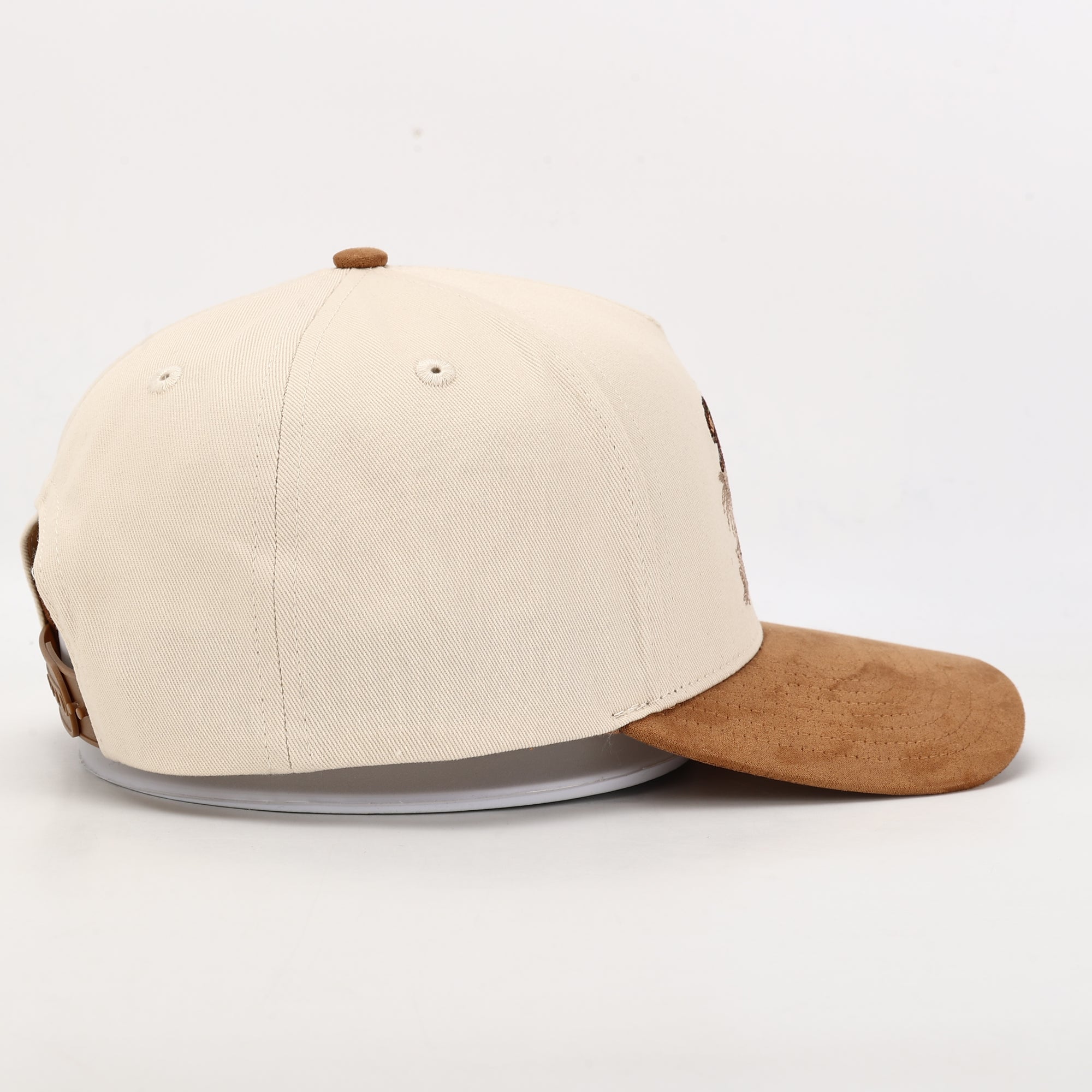 Beige and brown baseball cap on a light gray background