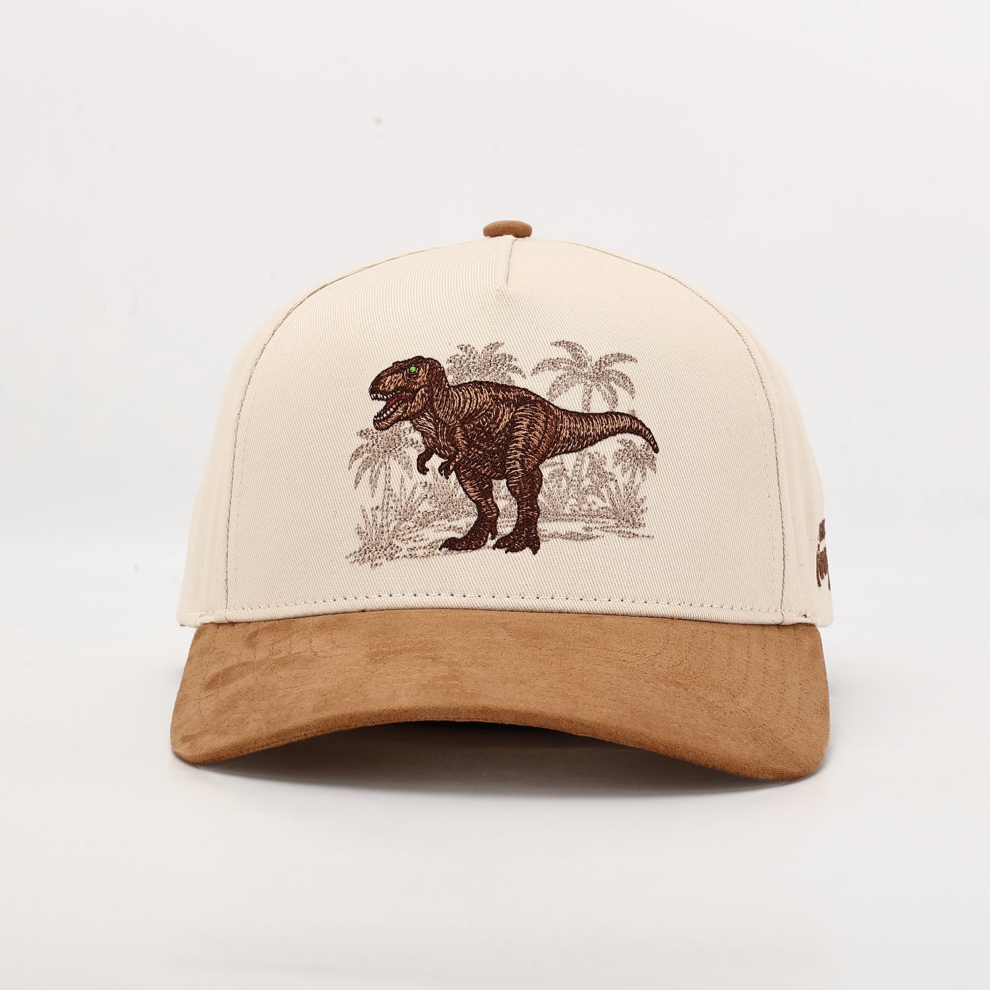 Beige Cap with a dinosaur design on a white background