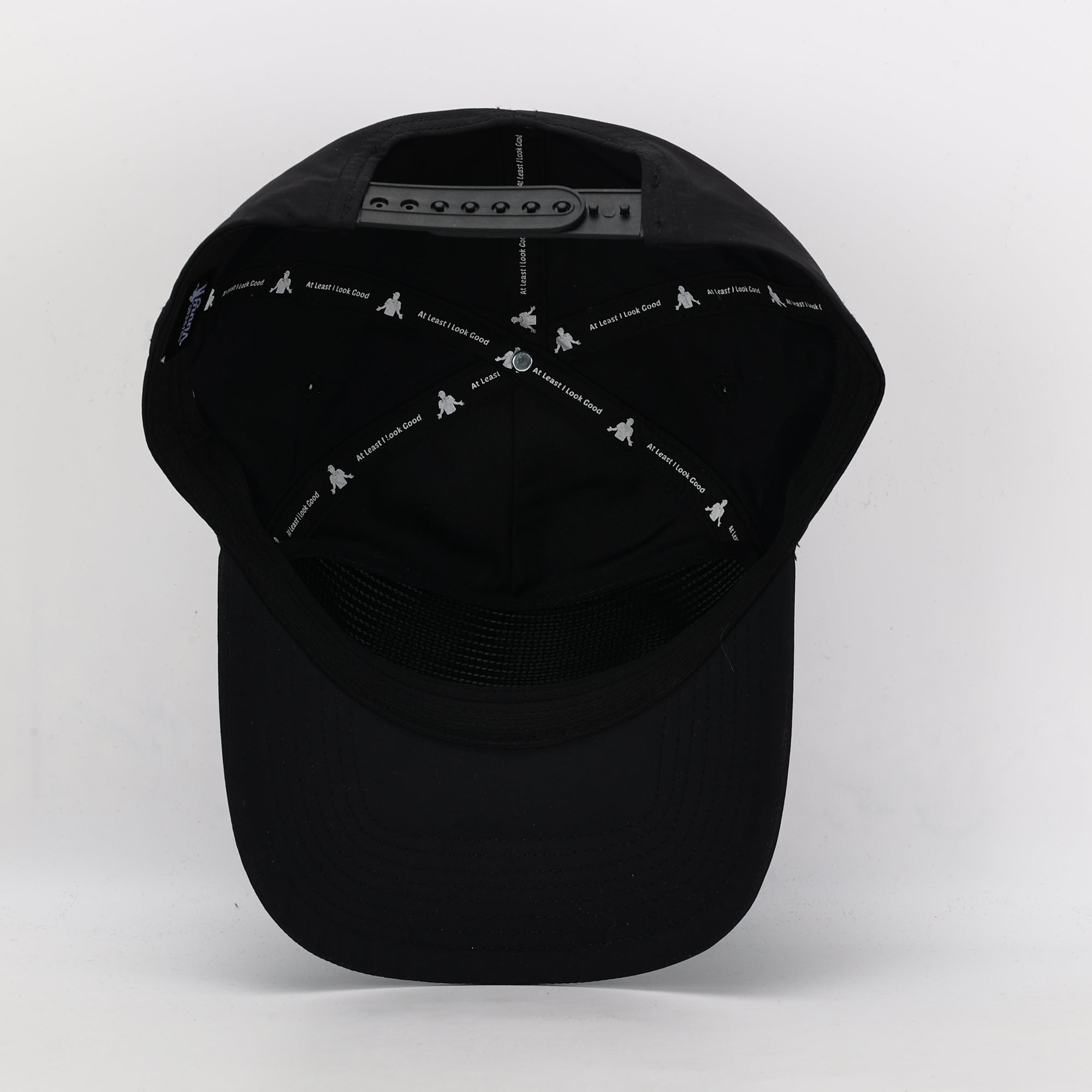 Black cap with white embroidered designs on a white background