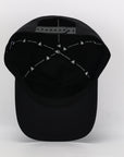 Black cap with white embroidered designs on a white background