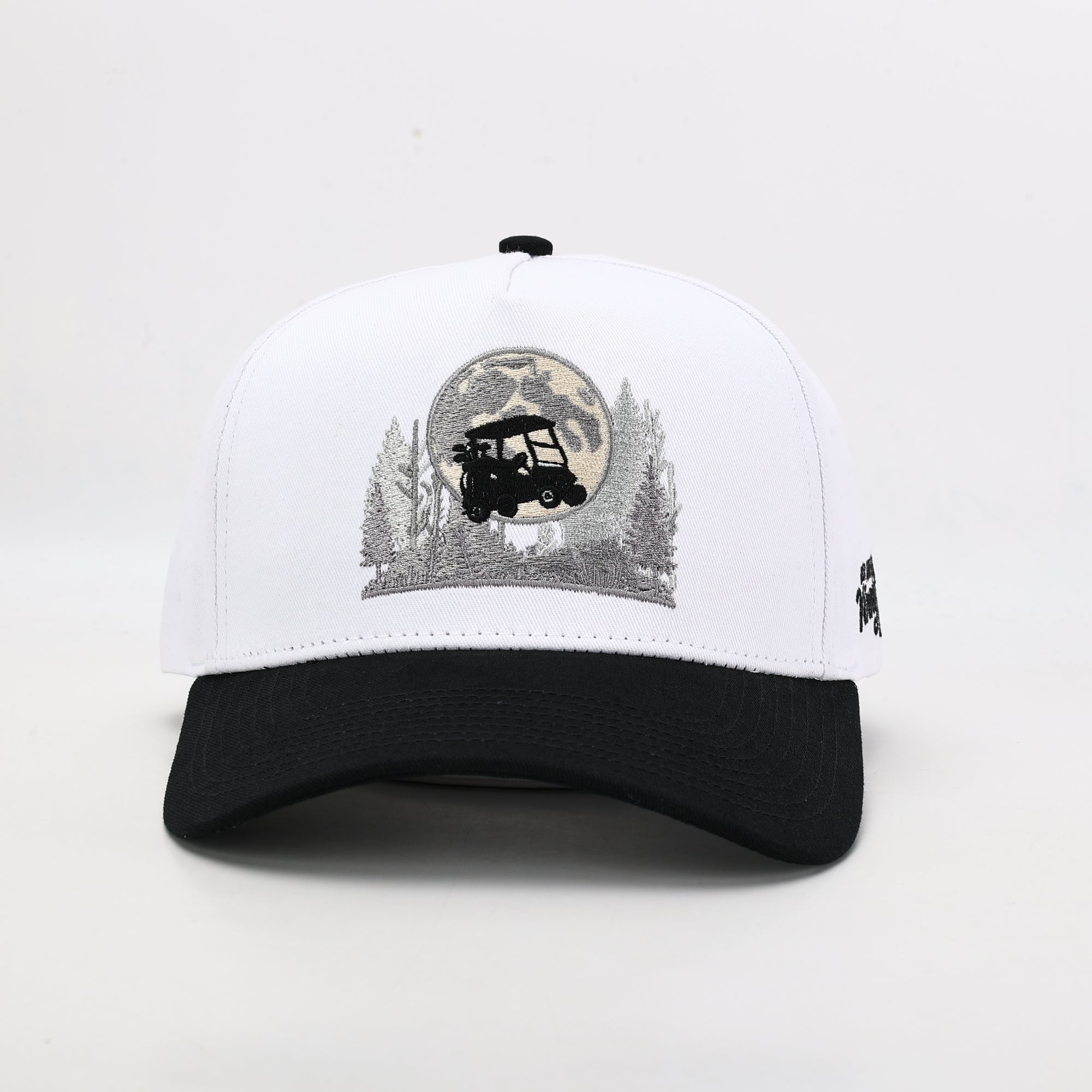 White and black cap with a graphic design on a light gray background