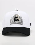 White and black cap with a graphic design on a light gray background