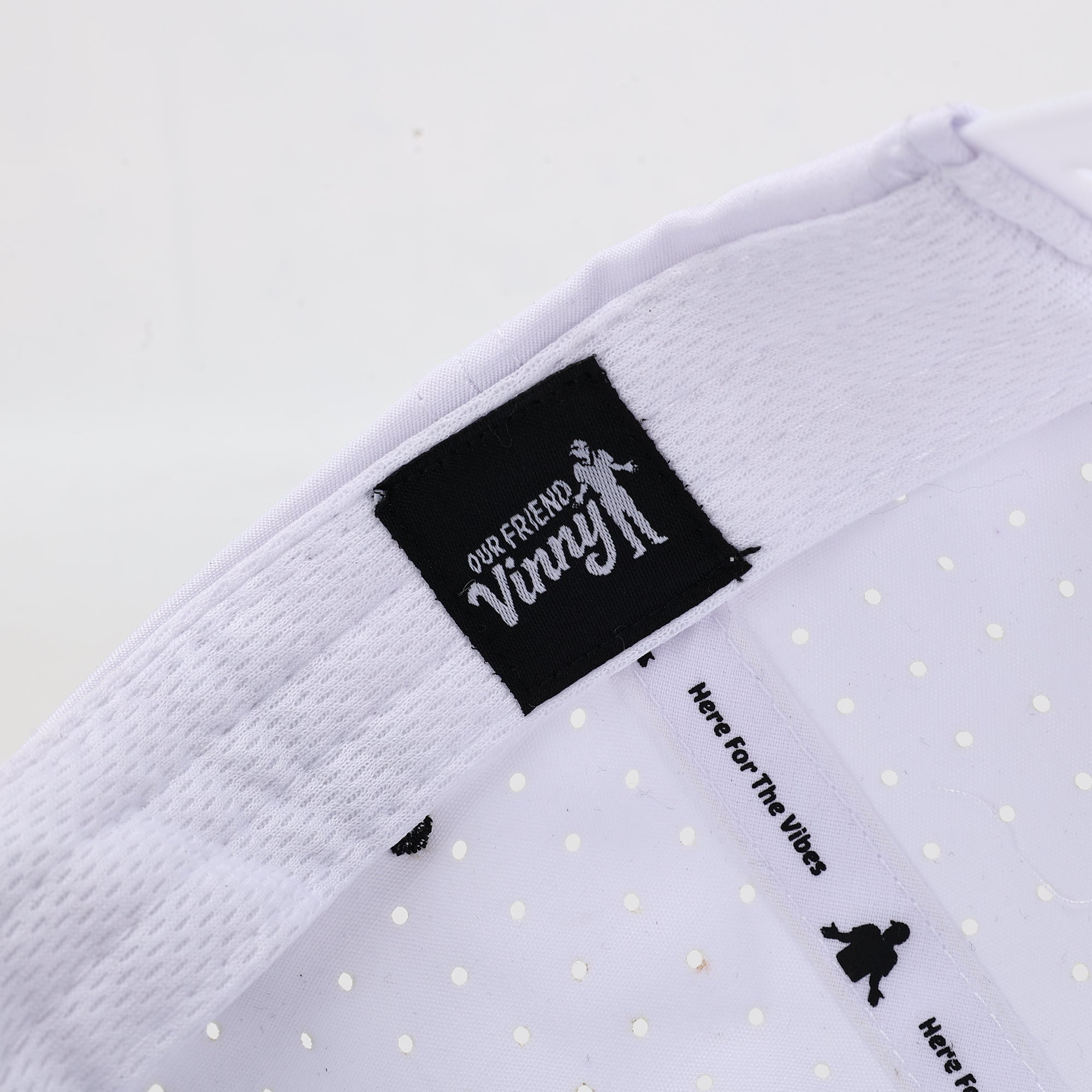 White fabric with black label and text on a light gray background