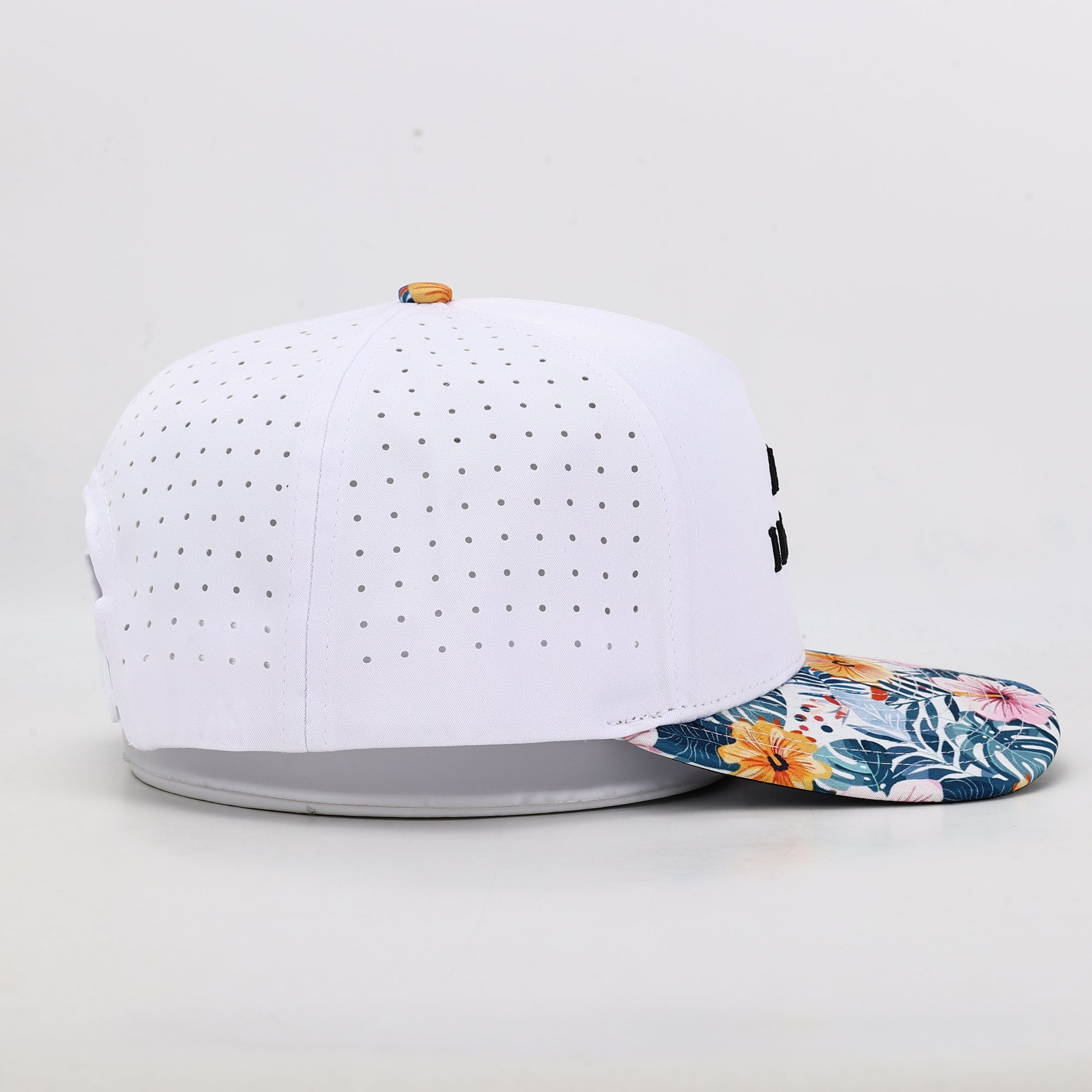 White baseball cap with floral brim on a light gray background