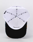 Baseball cap with white top and black brim on a light gray background