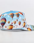 Colorful cap with hot air balloon design on a light gray background