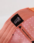 Pink baseball cap with perforated design 