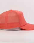 Coral pink cap with mesh back on a light gray background