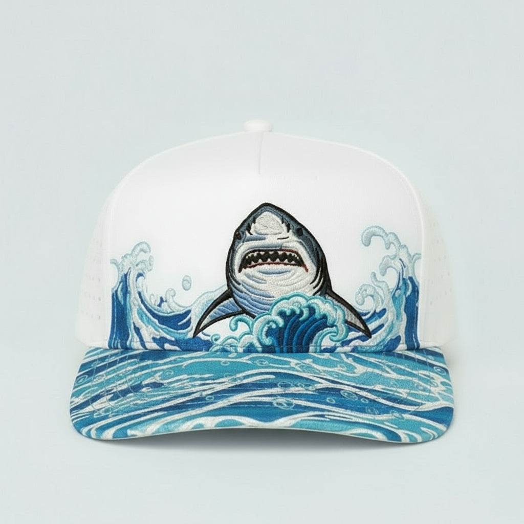 Cap with a shark design on a wave pattern against a light gray background