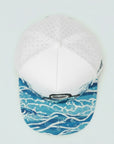 White cap with blue wave pattern on a white background