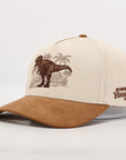 Beige and brown cap with a dinosaur and palm tree design on a white background