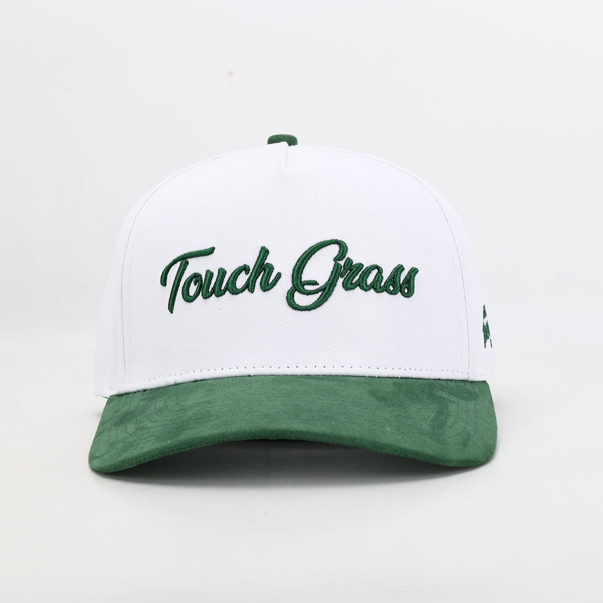 White cap with green brim and 'Touch Grass' text on a white background