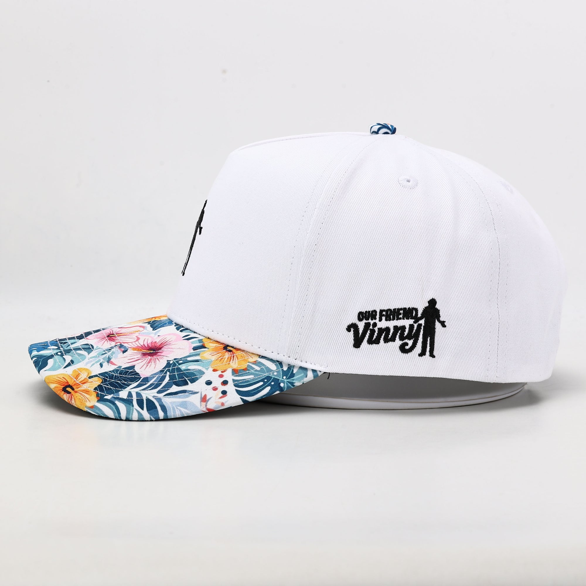 White golf hat with floral brim logo side 