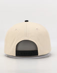 Beige cap with a black bill on a light gray background