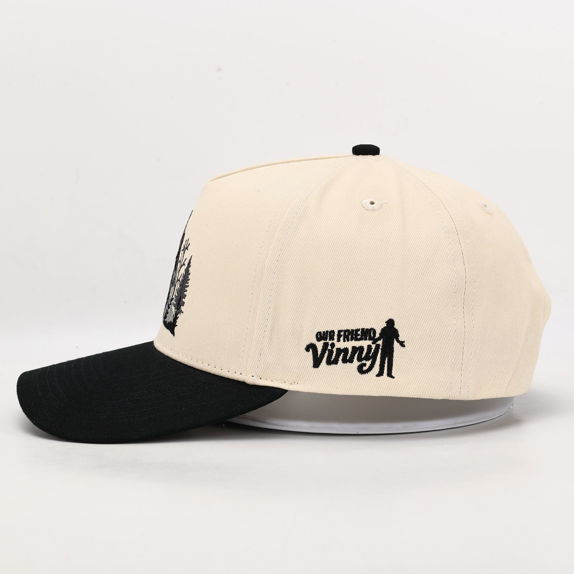 Beige and black cap with 'Old Friend Vinny' logo on a white background