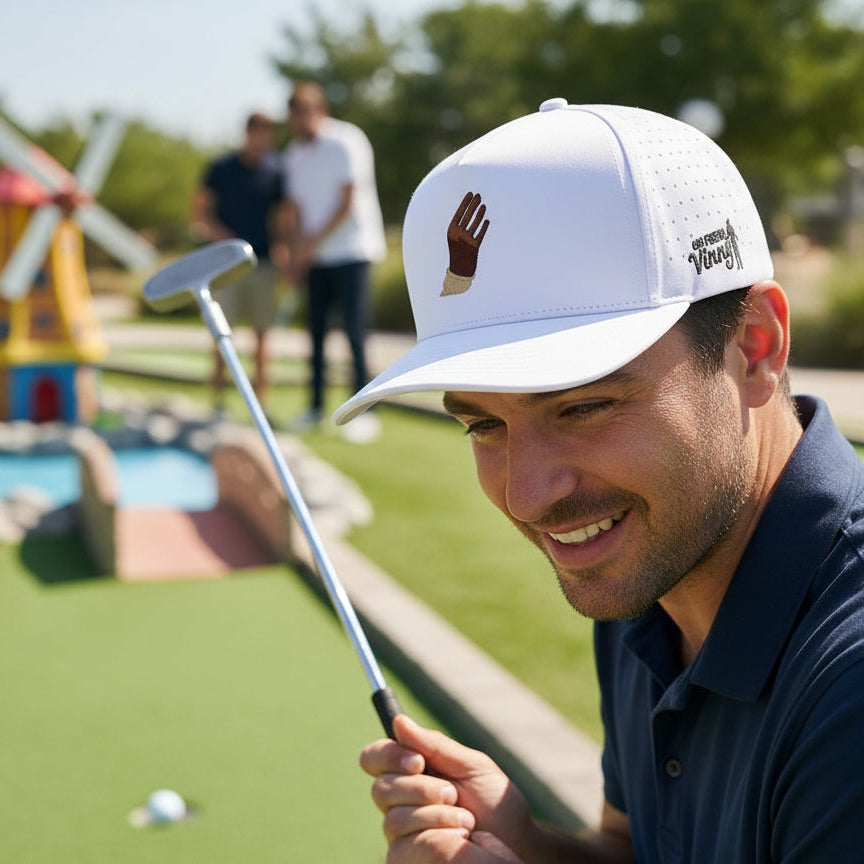 Man playing mini golf with a white cap and blue shirt