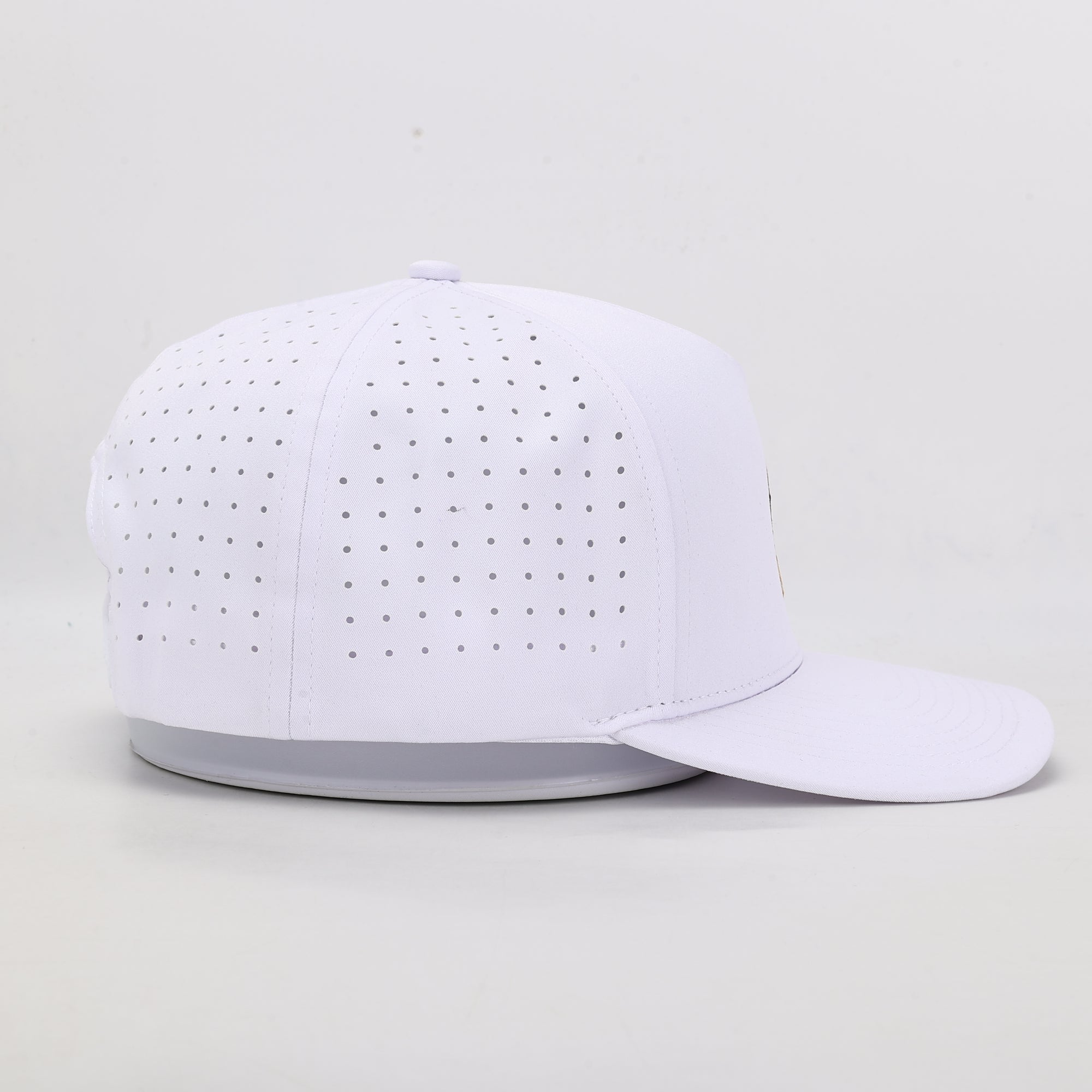 White baseball cap with perforated design on a light gray background