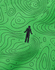 Close-up of the topographic map print and embroidered golfer logo on the Green Golf Topography Map golf polo