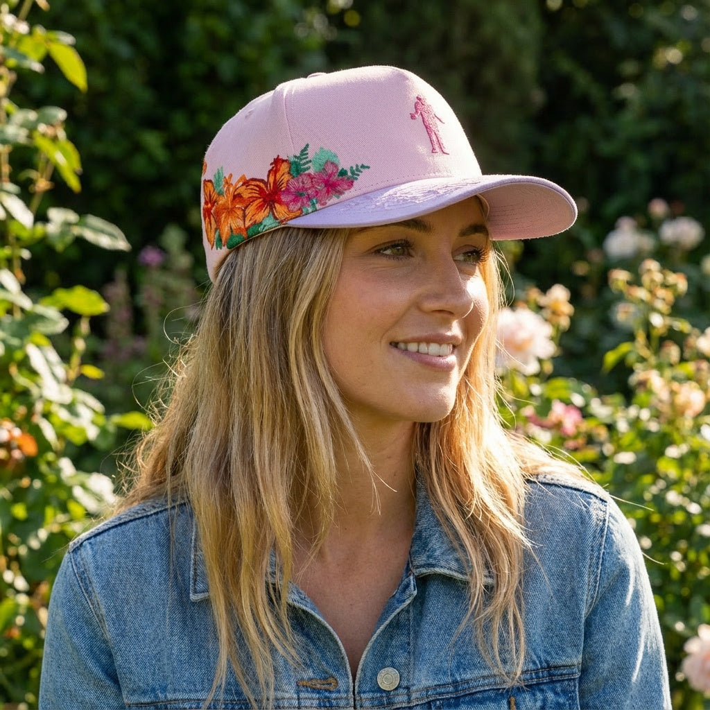 pink cap with floral designs on side 