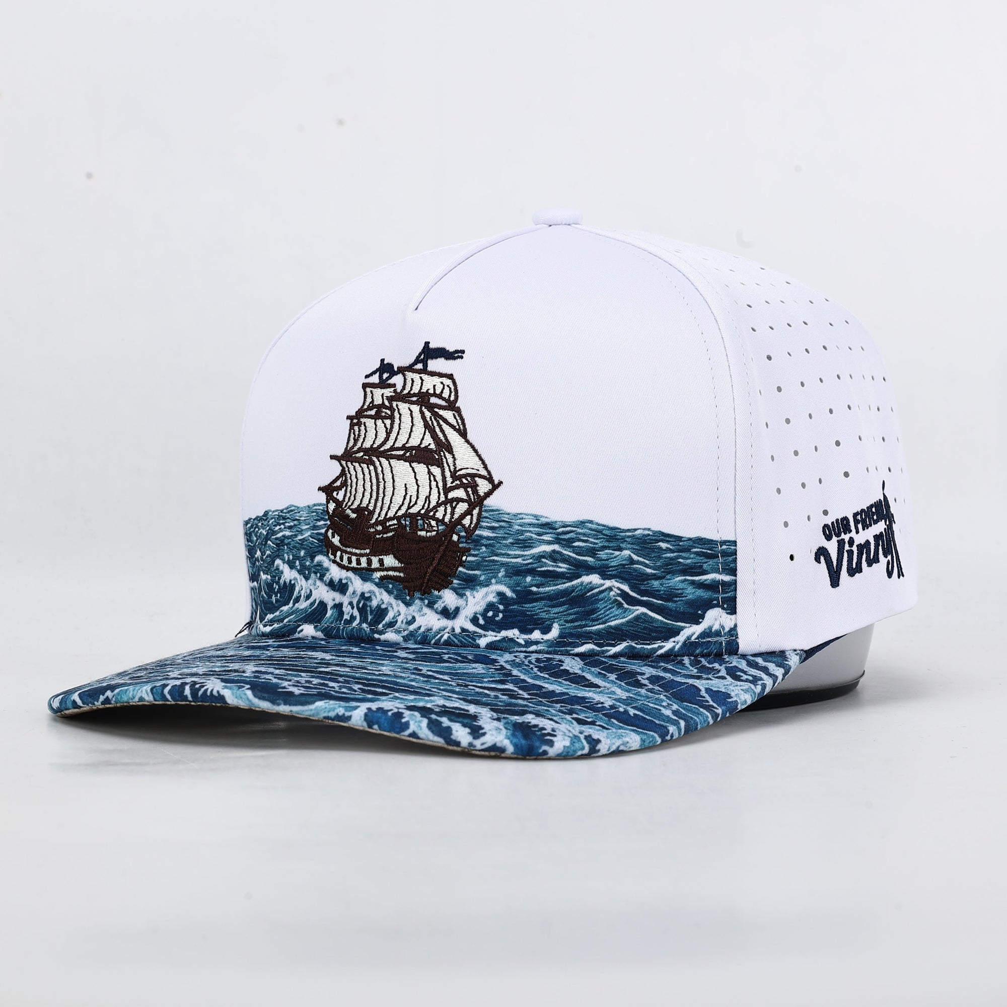 Cap with ship design on water pattern and visible brand logo