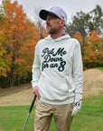Golfer wearing the white Put Me Down for an 8 hoodie on a fall golf course