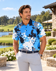 Man wearing the Spilled Ink blue splatter golf polo at a lakeside clubhouse
