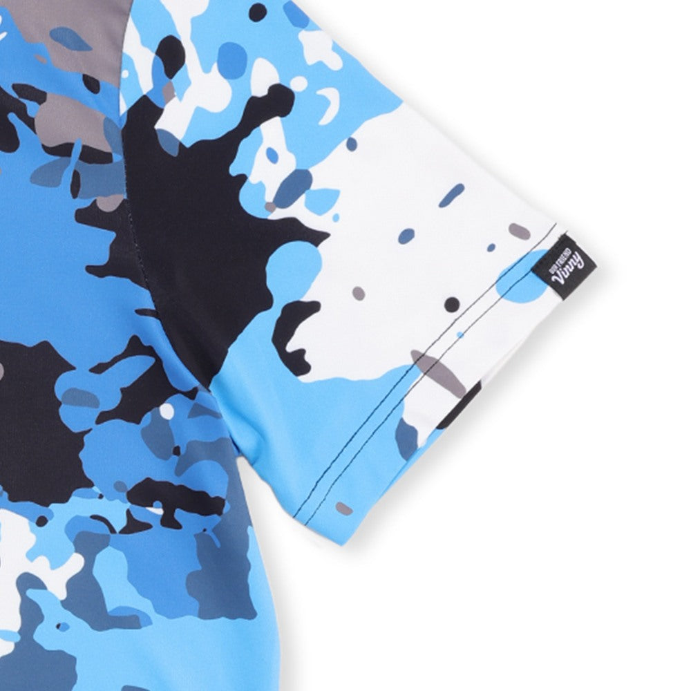 Close-up of the Our Friend Vinny tag on the sleeve of the Spilled Ink golf polo
