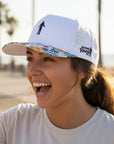 white performance golf cap with floral brim 