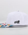 White performance cap with floral brim and 'Our Friend Vinny' logo on a light gray background